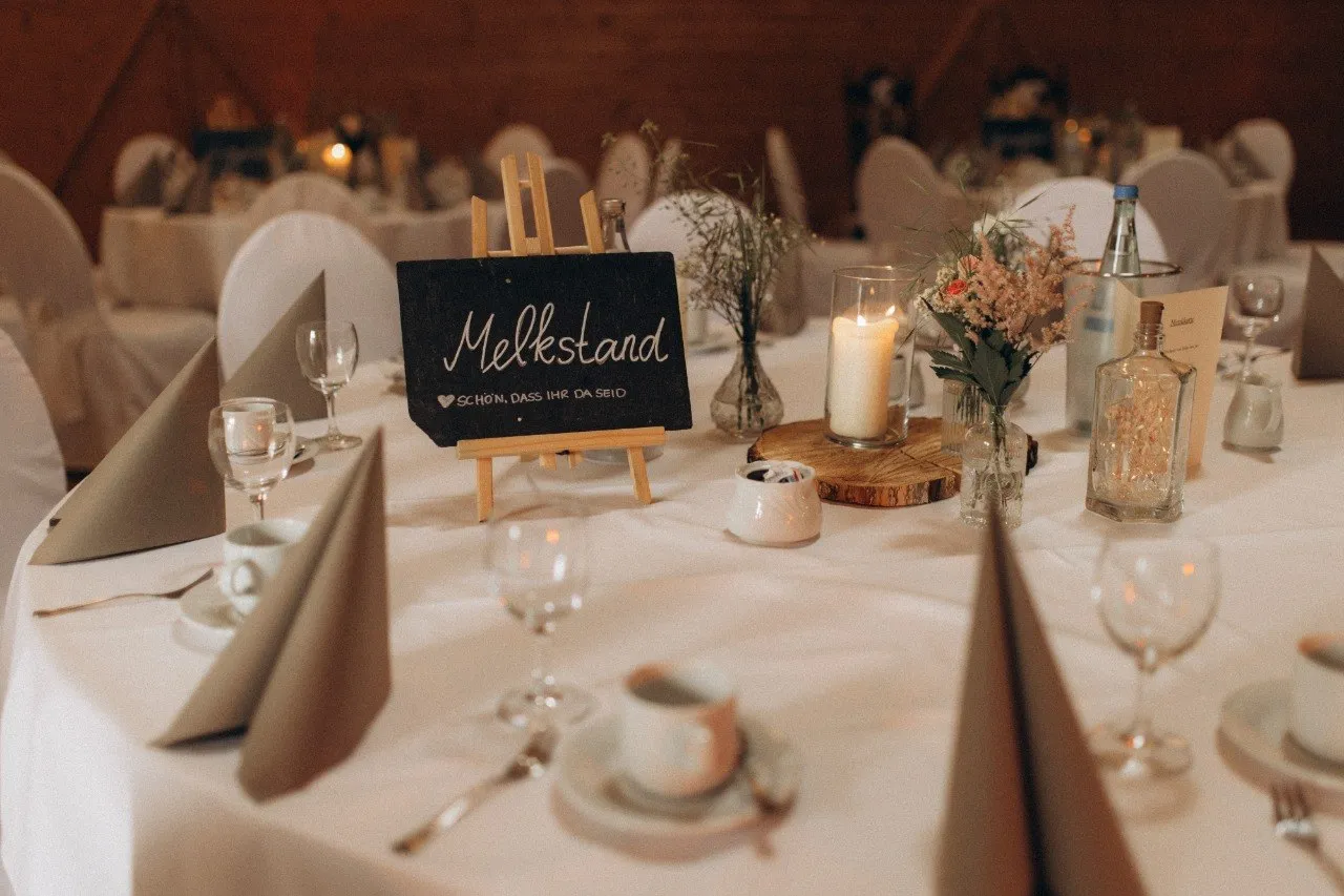 Hochzeitstisch mit Blumen, Kerzen und liebevollen Details